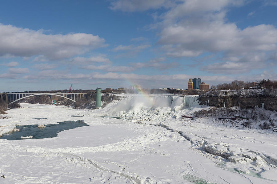 Niagara Falls Deep Freeze - Rainbow Bridge the American Falls and a Rainbow Of Course Photograph by Georgia Mizuleva