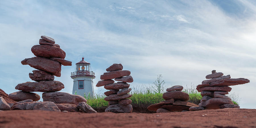 North Cape Lighthouse behind Stone Cairns Photograph by Chris Bordeleau