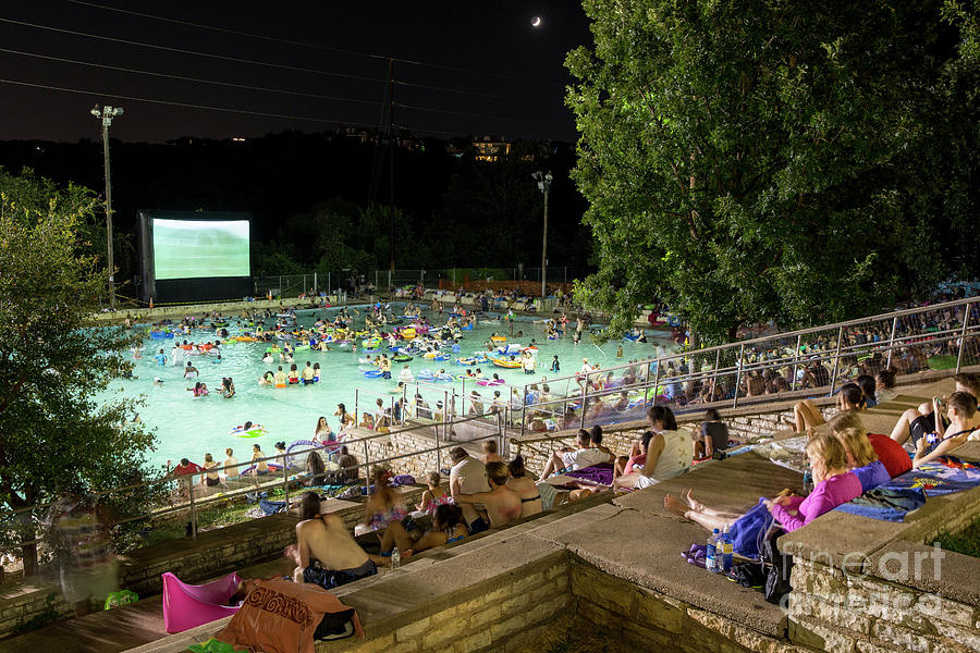 Summer Photograph - Nothing provides relief from the brutal Texas summer heat better than the Deep Eddy Pool Splash Movie Night as Pool-goers enjoy the movie while in refreshing 70-degree water by Dan Herron