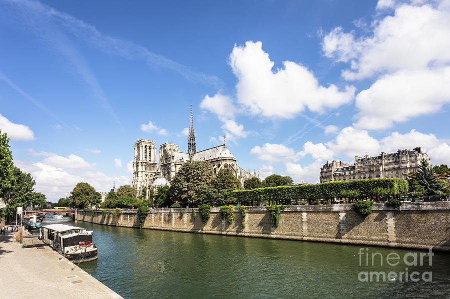 Notre Dame cathedral along the Seine riverbanks in Paris Photograph by Didier Marti