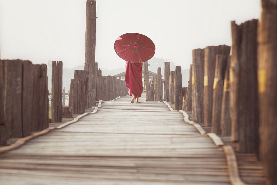 Novice walk on u bein wooded bridge  Photograph by Anek Suwannaphoom