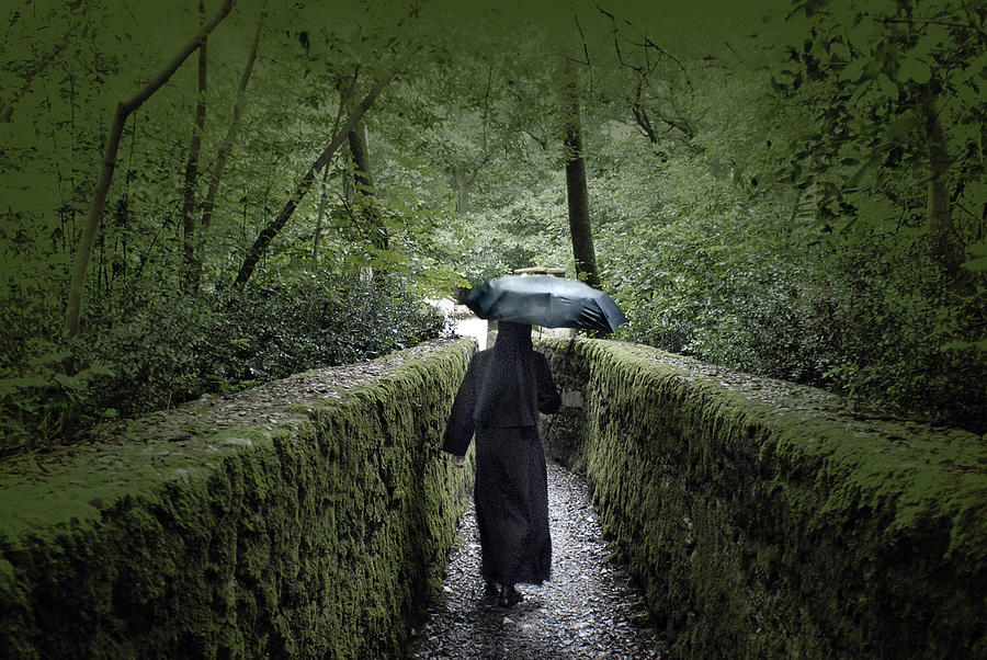 Nun in the Rain Photograph by Don Wolf