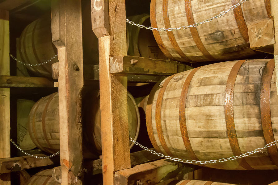Oak bourbon barrels on rack in warehouse Photograph by Karen Foley