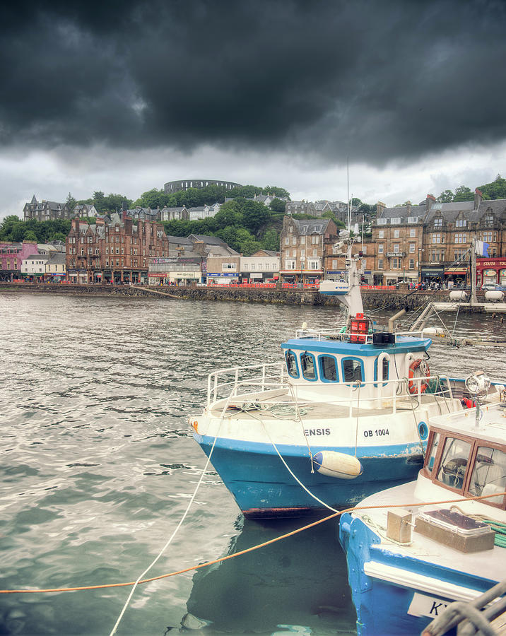 Oban Harbour under a dark sky Photograph by Ray Devlin