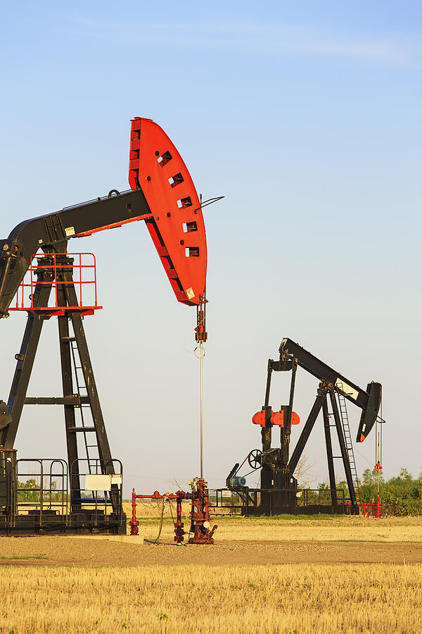 Oil Well Pump Jacks At Bakken Oil Field Photograph by Ken Gillespie