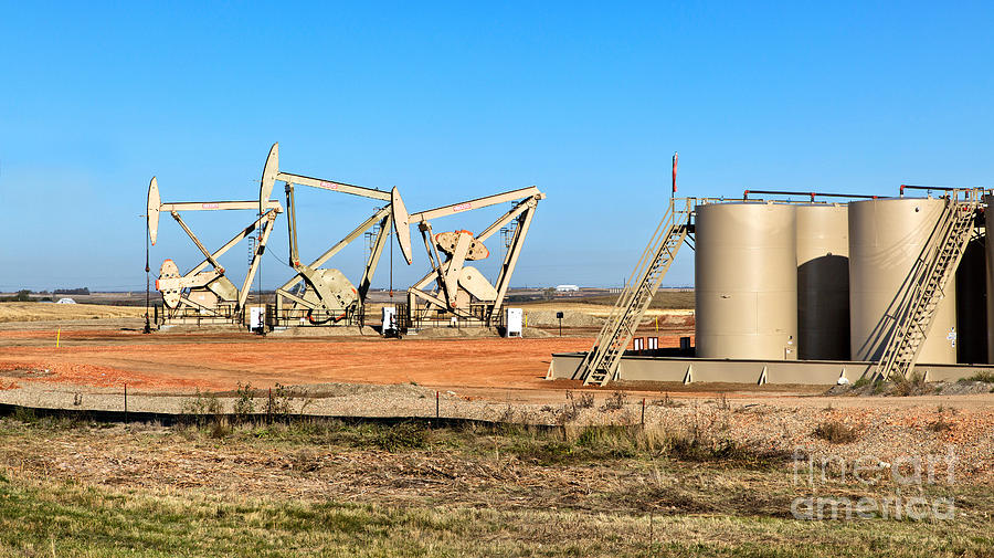 Oil Well Pumps And Storage Tanks Photograph by Inga Spence