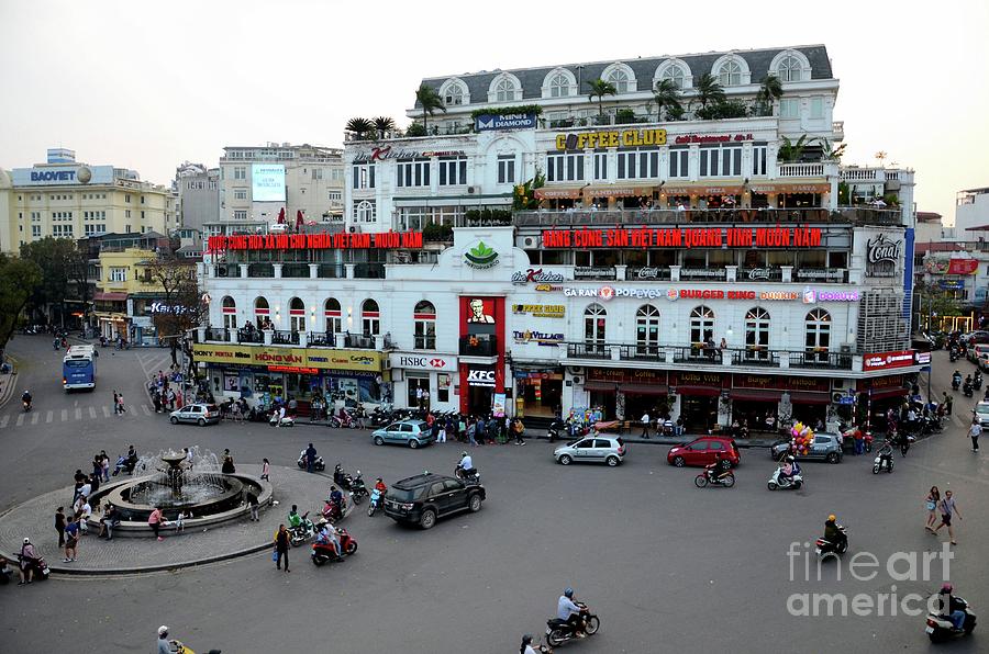 Old colonial building and roundabout with fast food restaurants Hanois Old Quarter Vietnam Photograph by Imran Ahmed