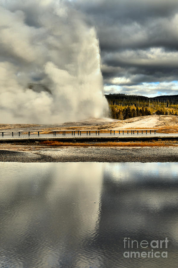 Old Faithful Erupts Under Stormy Skies Photograph by Adam Jewell