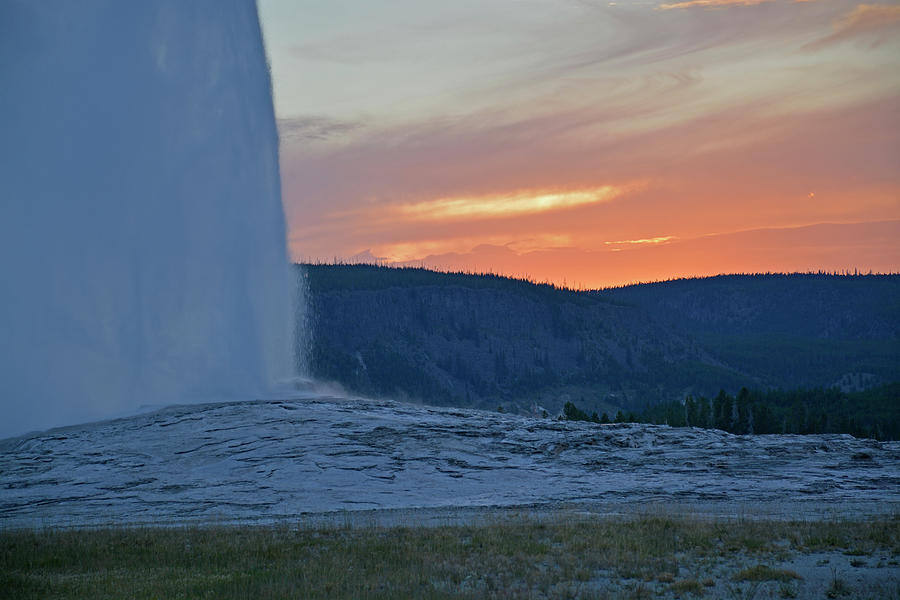 Old Faithful Geyser Erupting at Sunset Photograph by Bruce Gourley