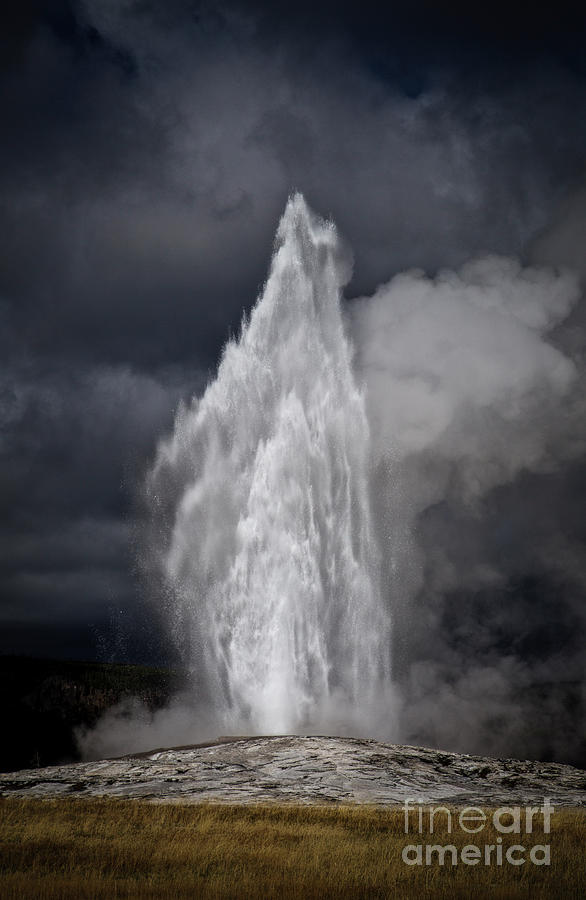 Old faithful with ominous skies Photograph by Bruce Block