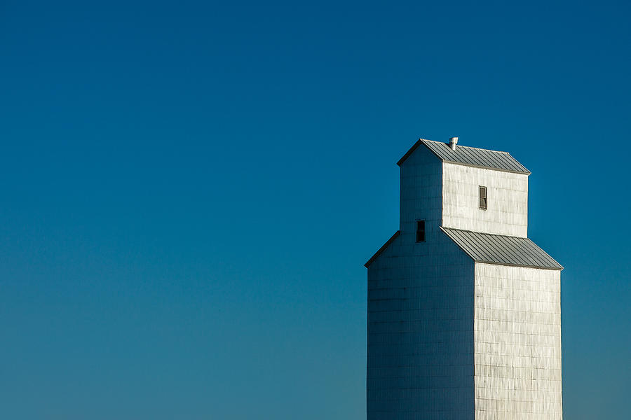 Old Grain Elevator Against Steel Blue Sky Photograph by Todd Klassy