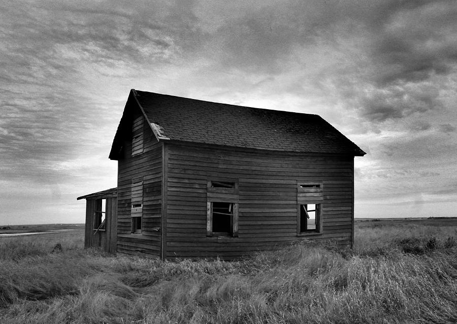Old house in a barren field Photograph by Jeff Swan