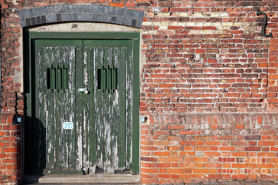 Old locked dock side doors Photograph by Simon Bratt