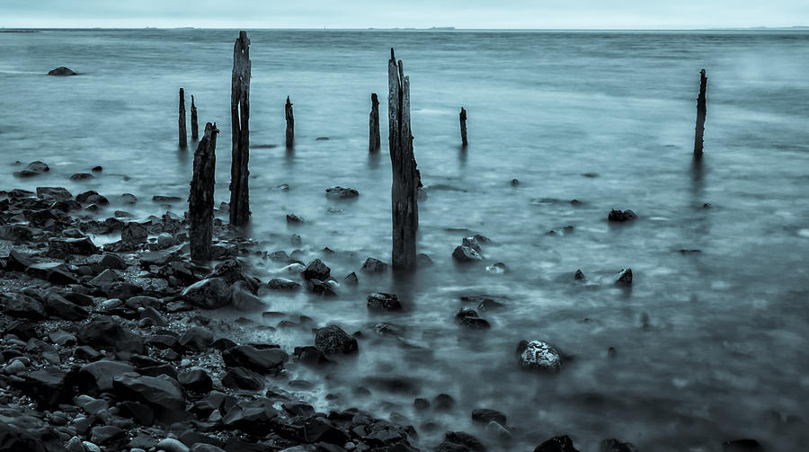 Old posts at Lindisfarne in Cyan. Photograph by John Paul Cullen