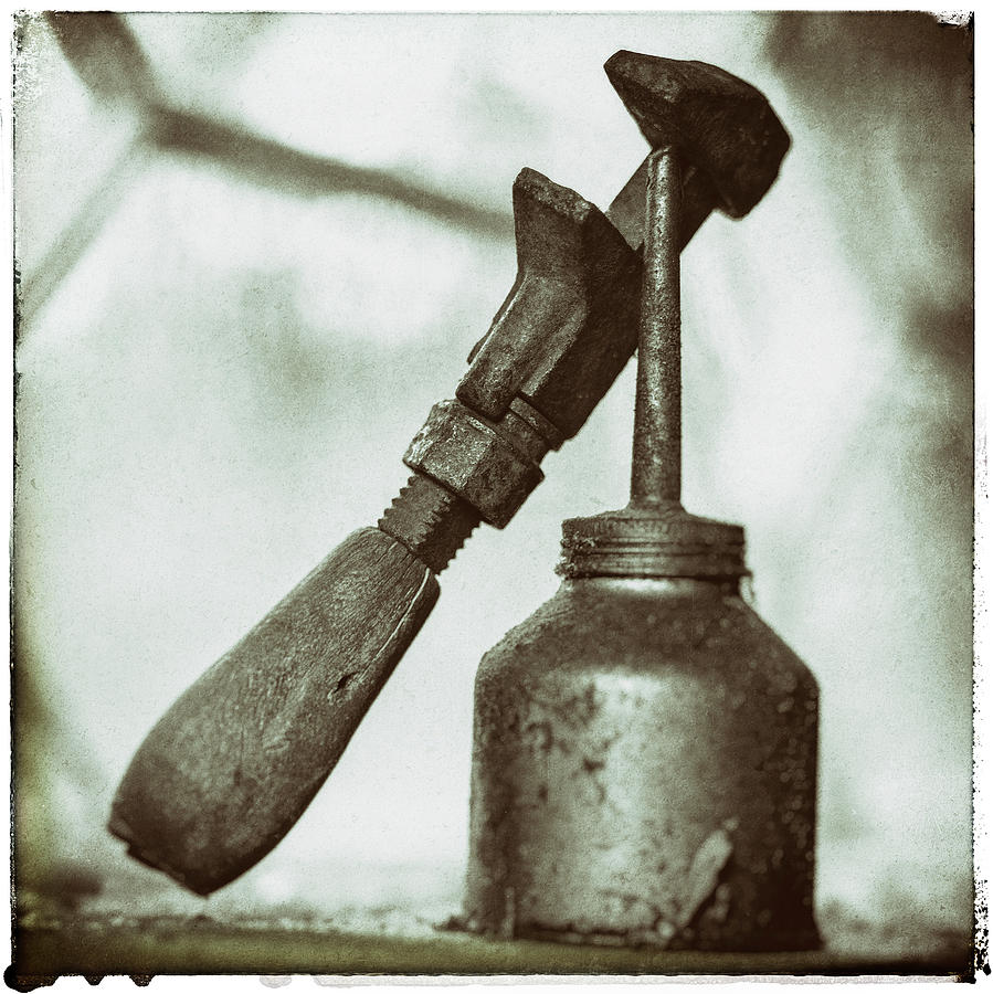 Old ratchet hanging on a rusty oil can Photograph by Anders Kustas