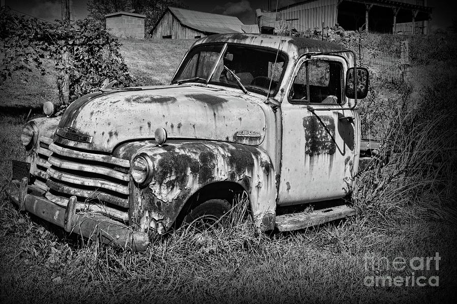 Old Rusty Chevy in black and white Photograph by Paul Ward