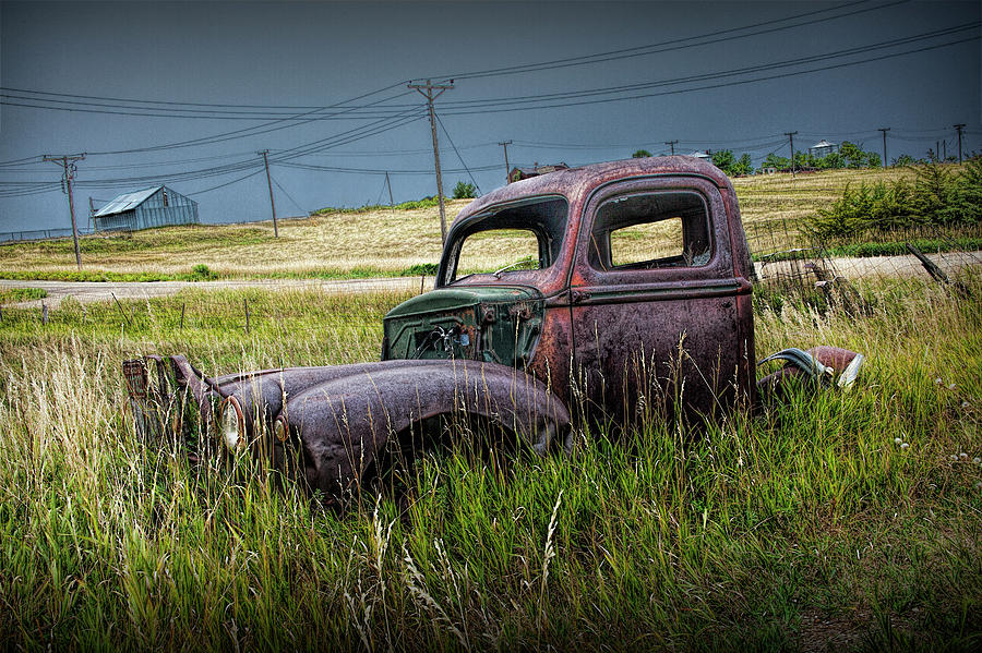 Old Rusty Truck lying in the Grass at the Ghost Town by Okaton South Dakota Photograph by Randall Nyhof