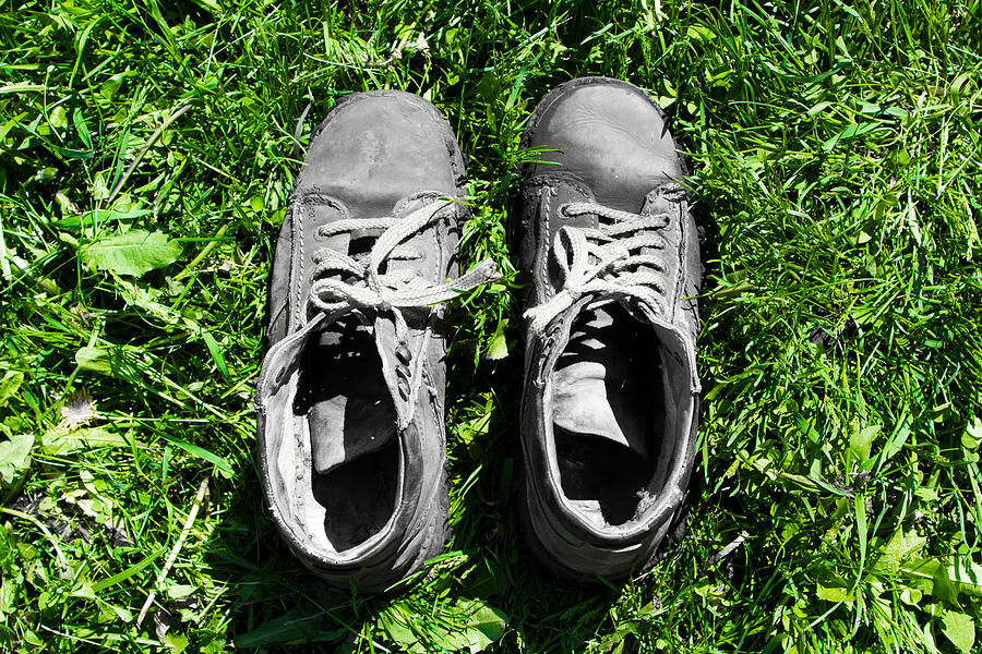 Old shoes on the green grass Photograph by Mikhail Piizzoff