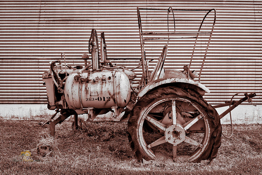 Old Tractor Against Quonset Hut Photograph by Jim Thompson