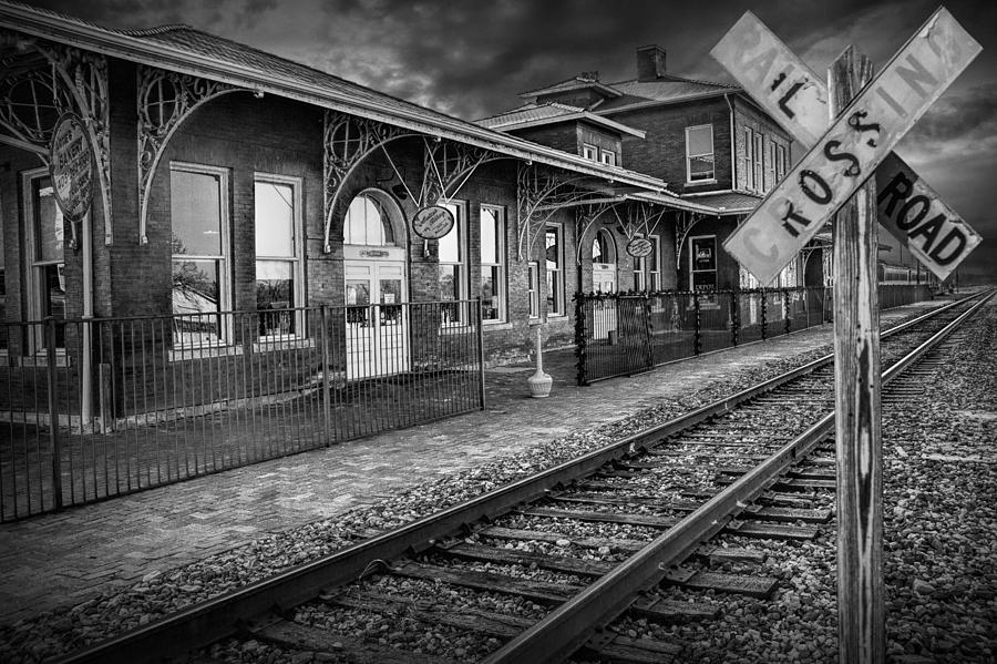 Old Train Station With Crossing Sign In Black And White Photograph
