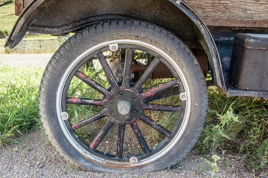 Old Truck Tire in Rural Rocky Mountain Town Photograph by Peter Ciro