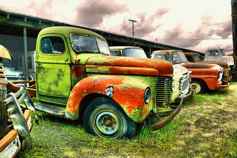 Old trucks in a row Photograph by Jeff Swan