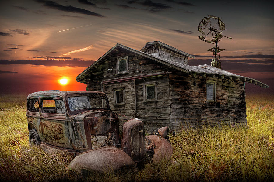 Old Vintage Abandoned Automobile with Rustic Building and Windmill Photograph by Randall Nyhof