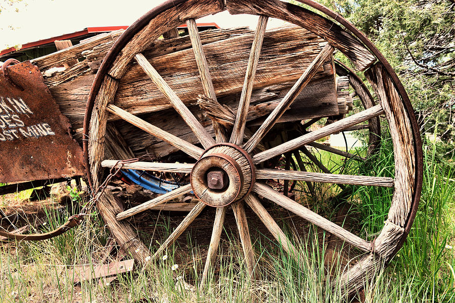 Old wagon wheel Photograph by Jeff Swan