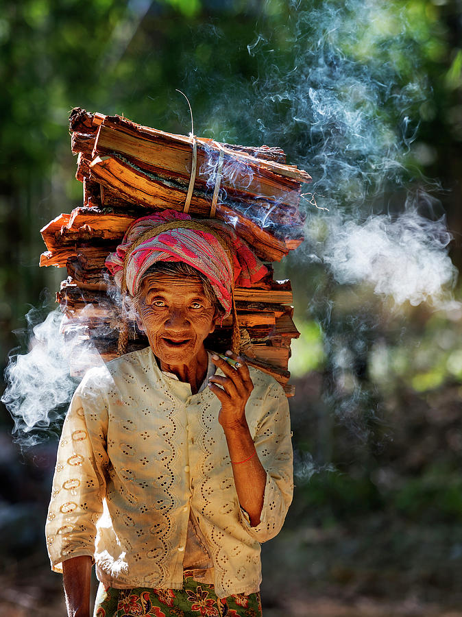 Old woman carrying wood-logs on her head Photograph by Pradeep Raja PRINTS