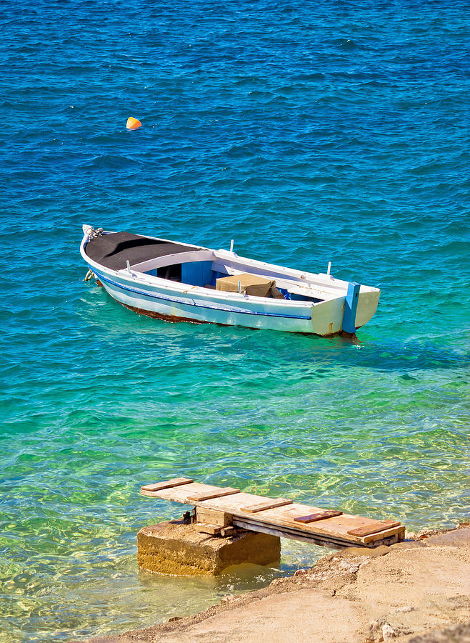 Old wooden fishermen boat on turquoise beach Photograph by Brch Photography