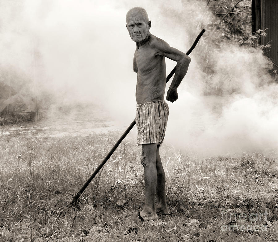 Older Cambodian Male Burning Leaves  Photograph by Chuck Kuhn