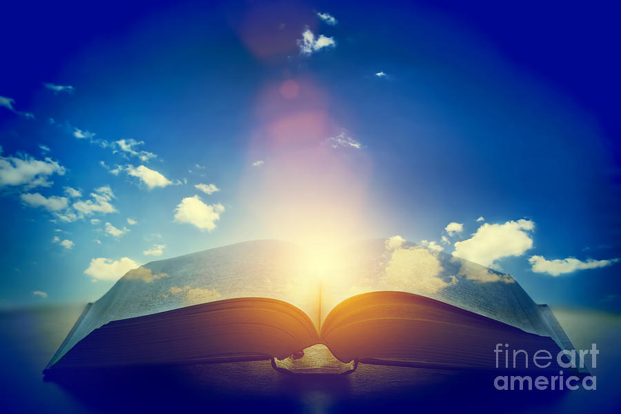 Open old book with light from the sky Photograph by Michal Bednarek
