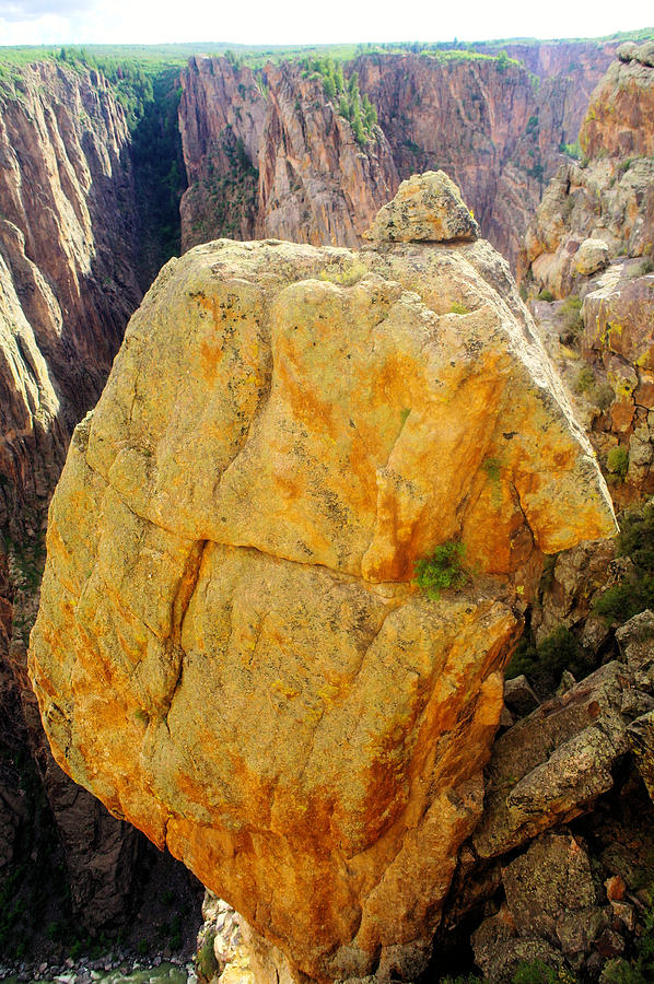 National Parks Photograph - Orange boulder in the black canyon of the Gunnison river. by Jeff Swan