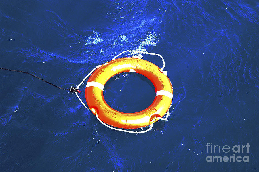 Orange life buoy in blue water Photograph by Jacki Costi