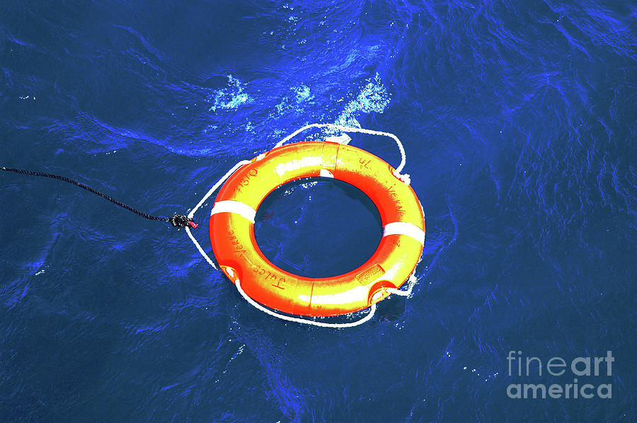 Rope Photograph - Orange life buoy with rope in the water by Jacki Costi