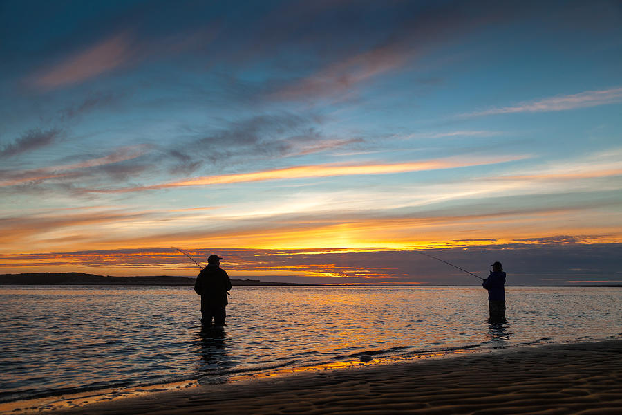 Oregon couple fishing at sunset. Photograph by Scott Slone