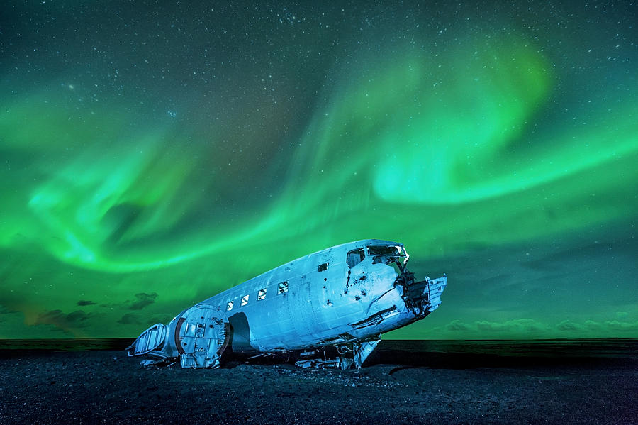 Vintage Photograph - orthern lights over plane wreck  in Iceland by Jakkree Thampitakkull