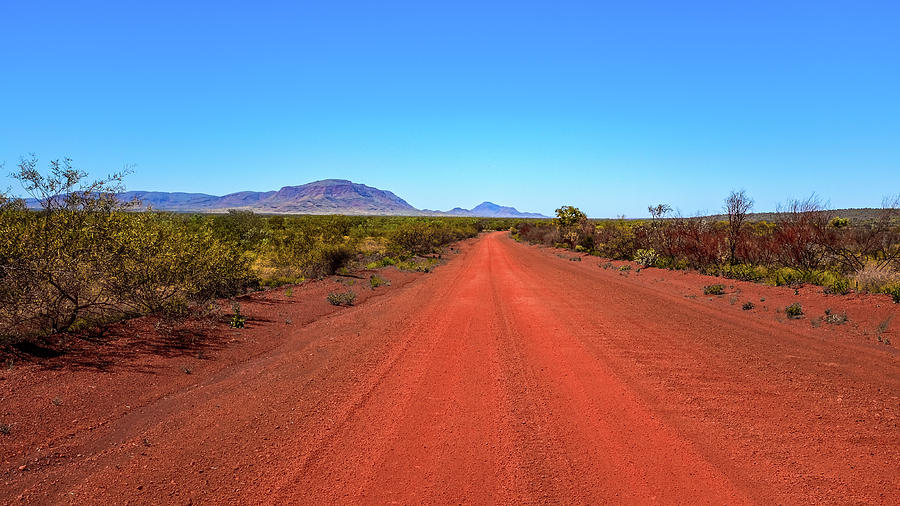 Limited Usikker Alabama Outback red dirt road leading to mountain and blue sky Photograph by Justin  Mckinney - Pixels