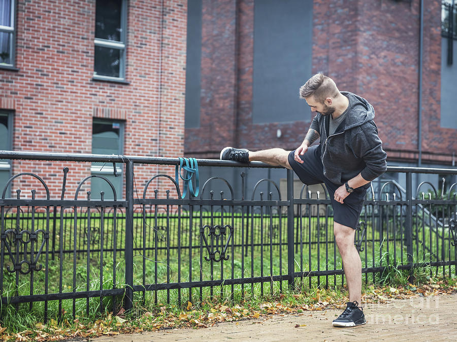 Outdoor streching. Healthy exercising habits. Photograph by Michal Bednarek