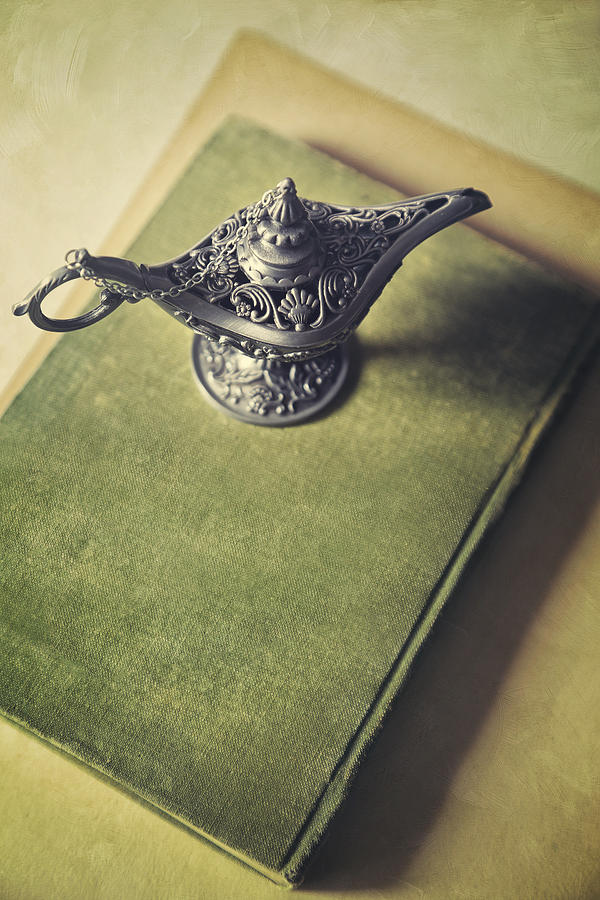 Over head view of Genie lamp on a book Photograph by Sandra Cunningham