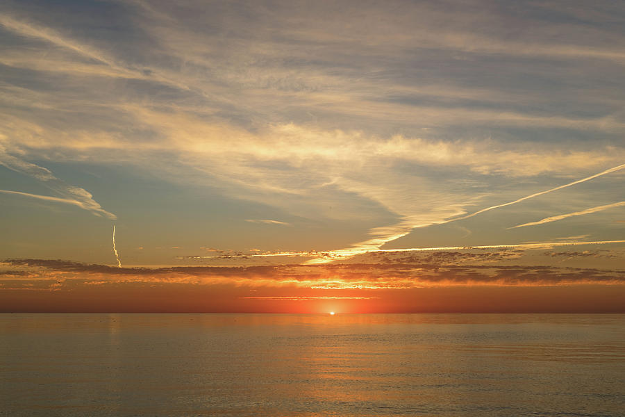 Painted by Airplanes - Contrails Streak the Sky at Sunrise Photograph by Georgia Mizuleva