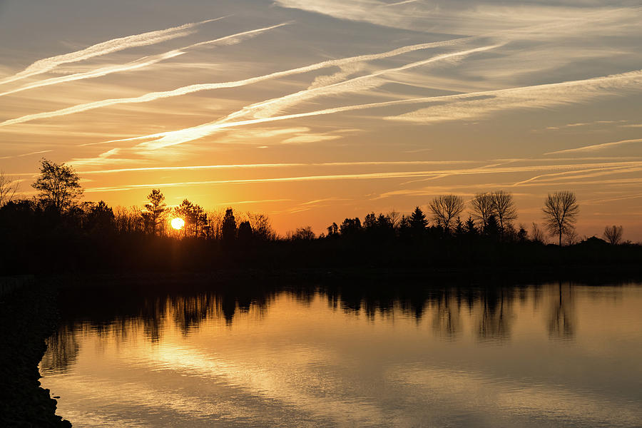 Painted by Airplanes - Reflecting on Contrails Streaked Sunrise Sky at the Lake Photograph by Georgia Mizuleva