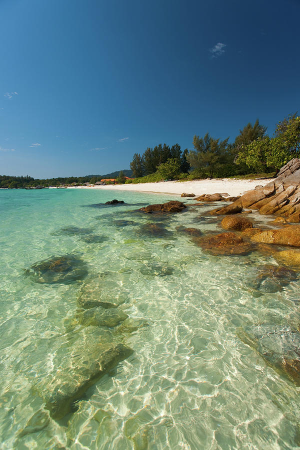 Turquoise colored crystal clear water at a rocky island