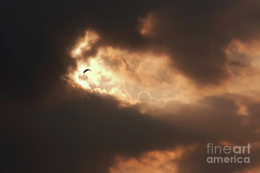 Paraglider in the torn clouds Photograph by Michal Boubin