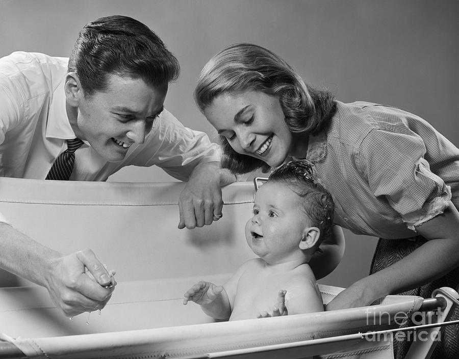 Parents Bathing Child In Fold-up Tub Photograph by H. Armstrong Roberts/ClassicStock