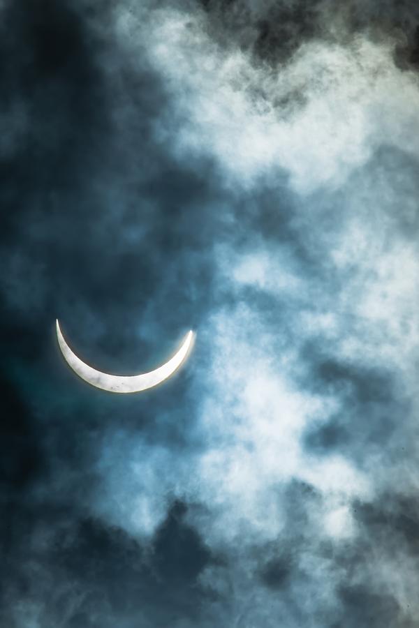 Partial Solar Eclipse Through Clouds Photograph by Alex Grichenko