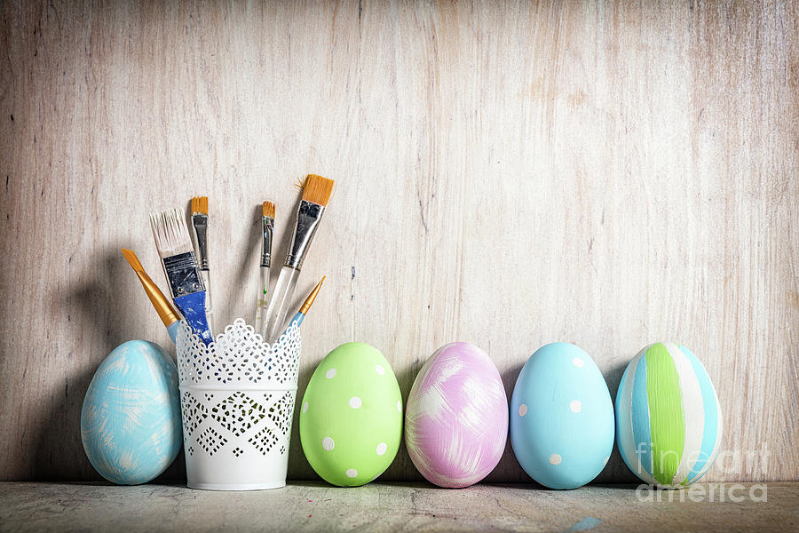 Pastel Easter eggs and brushes in a rustic cup Photograph by Michal Bednarek