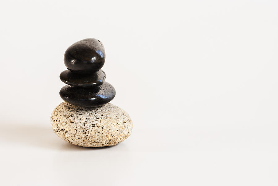 Pebbles Photograph - Pebbles stacked on a white background by Vishwanath Bhat