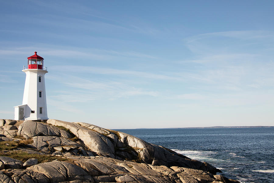 Peggys Cove Lighthouse, Nova Scotia, Canada along rocky shores Photograph by Karen Foley