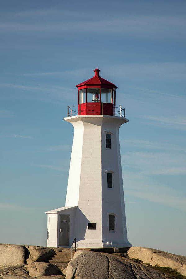 Peggys Cove Lighthouse, Nova Scotia, Canada on rocky shores  Photograph by Karen Foley
